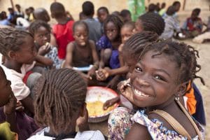 Bahadou 2 school in Timbuctu. A group of children eat their warm mid-day meal offered by the World Food Programme through a school canteen programme. The Timbuctu region is situated about 1050 km from the capital Bamako and is the 6th and largest region of Mali.