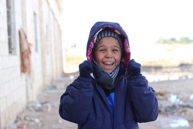 On 12 December 2016, Ahmed gives a radiant smile as he finds out that the clothes he was given were exactly his size. Over 5,000 children recently displaced from eastern Aleppo city have received winter clothes provided by UNICEF. Displaced children like Ahmed are especially vulnerable at this time of year. As temperatures drop, children are at risk of hypothermia, pneumonia and other deadly diseases. With both parents dead and no other relatives to look after him or his four siblings, Ahmed came to the shelter from East Aleppo with neighbors. Winter is the latest threat to children in conflict-ridden Aleppo. As people continue to flee the besieged Syrian city of Aleppo, UNICEF is working to reach displaced families with the supplies they need to survive the brutal winter. Some children have lost or become separated from their families, leaving them even more vulnerable. Five days ago, 10-year-old Ahmed arrived in Jibreen, an industrial district on the outskirts of Aleppo. Ahmeds parents were killed in the vicious conflict engulfing the city. He and his four siblings have nobody to take care of them and help keep them warm. The journey to Jibreen was gruelling for five-year-old Rahaf, her two-year-old brother Wael, and their mother, who fled their home in east Aleppo. Their mother, a widow who suffered a shrapnel wound on her leg, had to wheel her children for hours until they could be transported by bus to the Jibreen shelter.